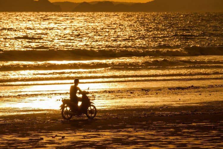 Motorcycle on the beach on sunset
