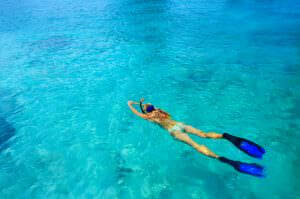 Young woman ig snorkeling in tropical lagoon