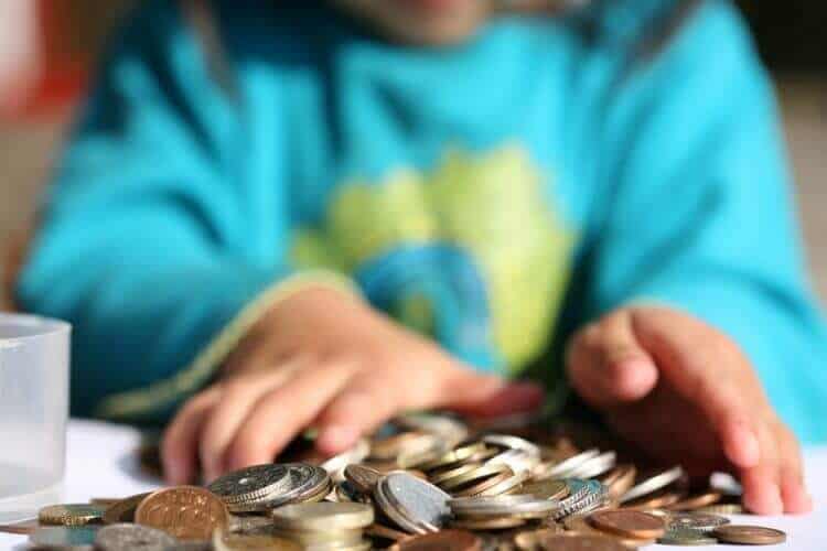 child playing with coins