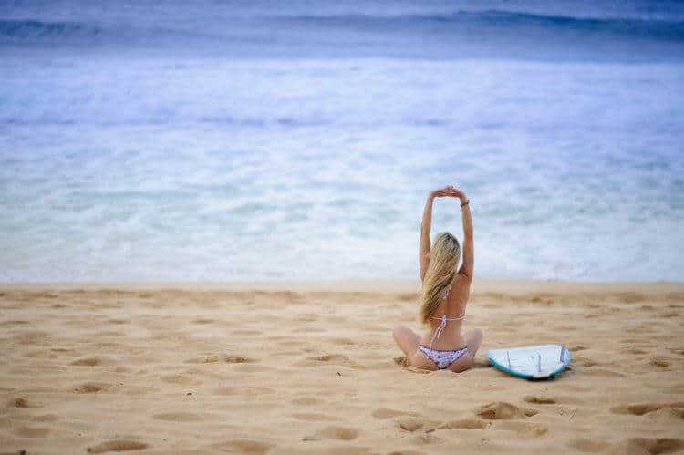 Girl with surfboard at beach