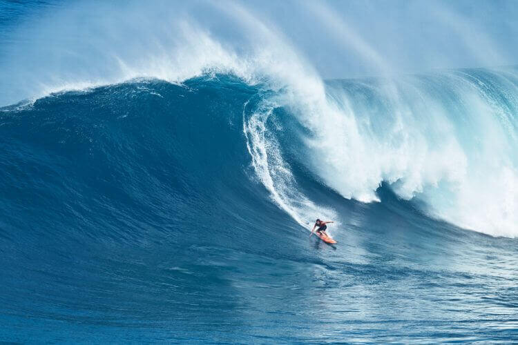 MAUI, HI - JANUARY 16 2016: Professional surfer Tyler Larronde rides a giant wave at the legendary big wave surf break known as "Jaws" on one the largest swells of the year.