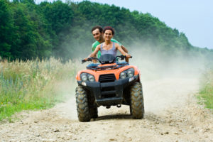 Couple Riding ATV - How to Avoid Kids While on Vacation in Hawaii