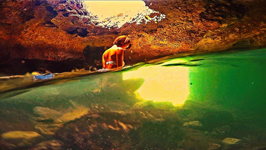 girl taking in the breathtaking views of the green water and sunlight