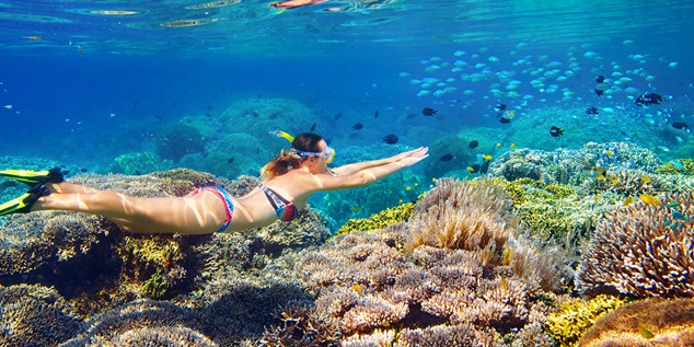 girl snorkling off of the Na Pali Coast