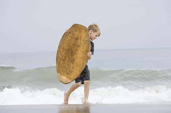 little boy bodyboarding